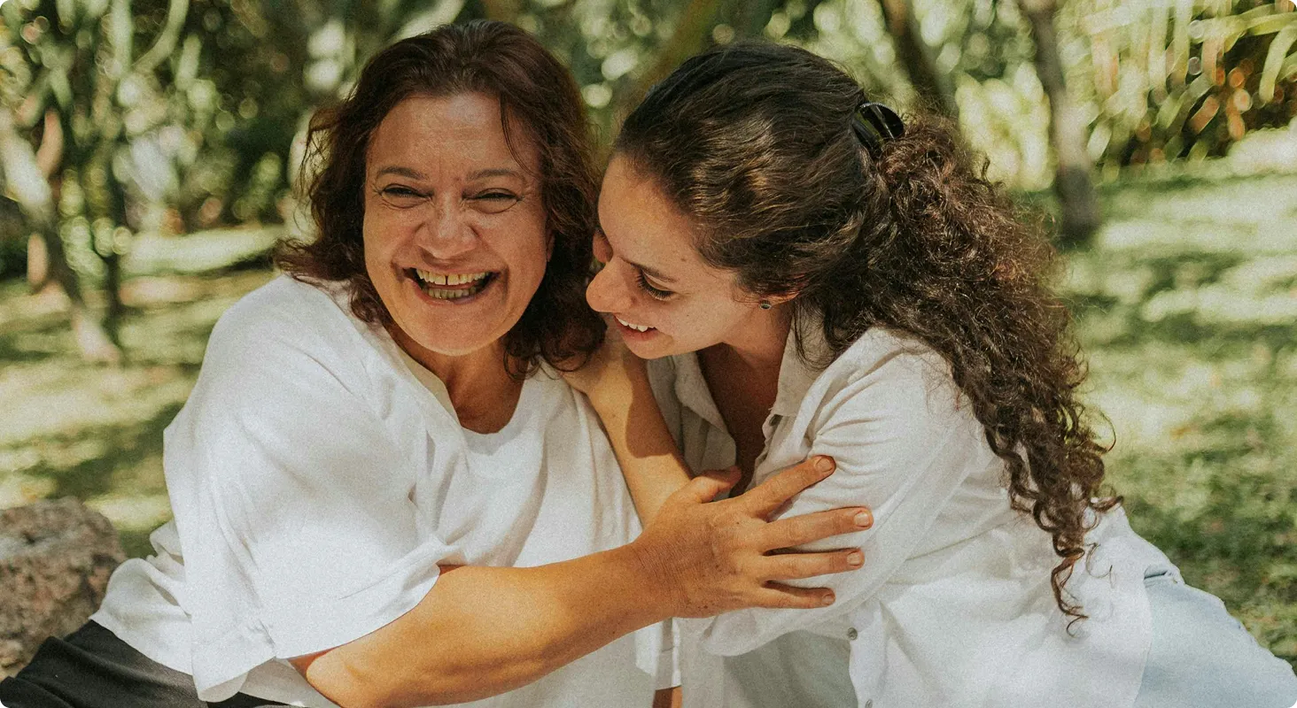 Two women laughing together outdoors
