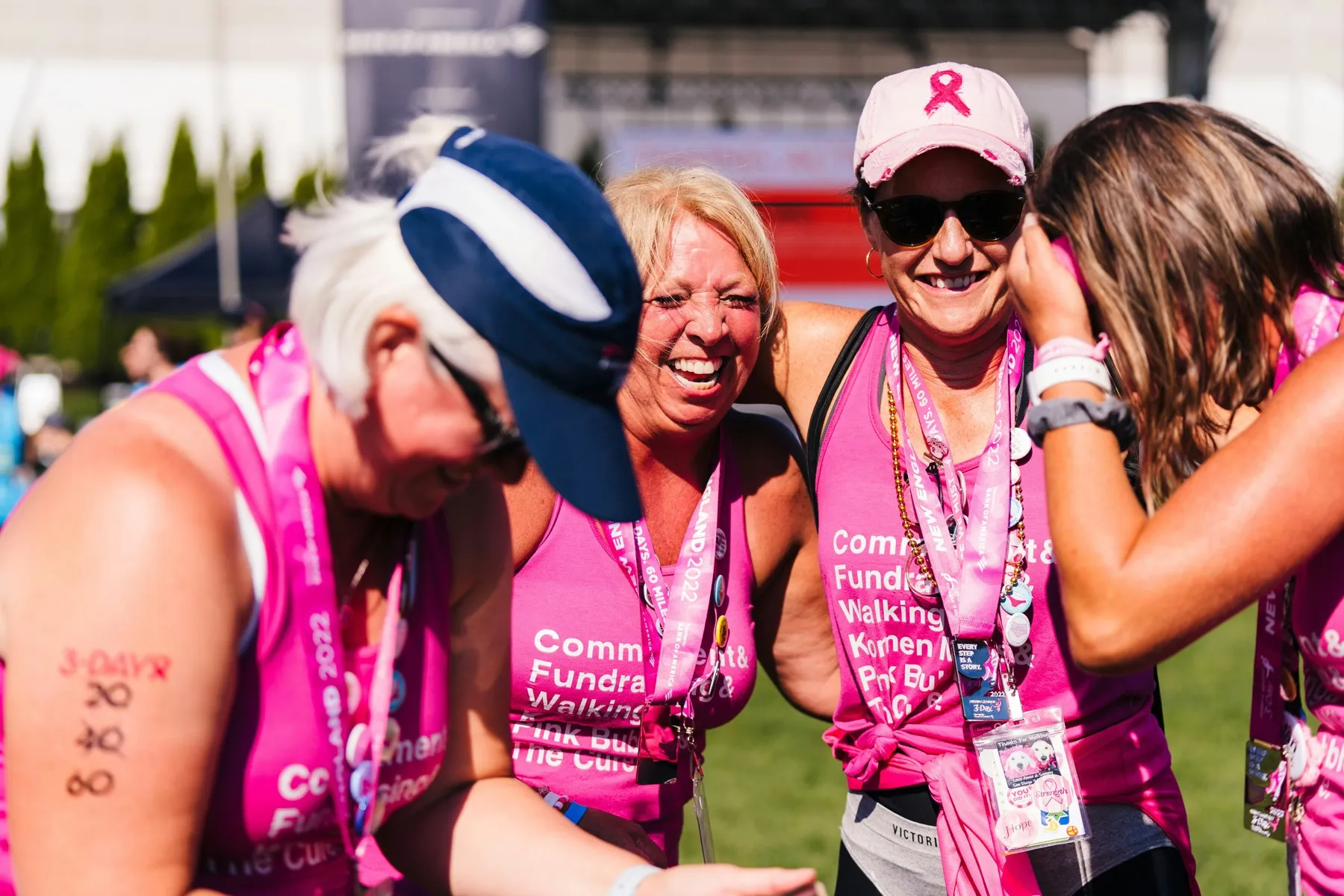 Participants at a charity walk laughing together in matching shirts